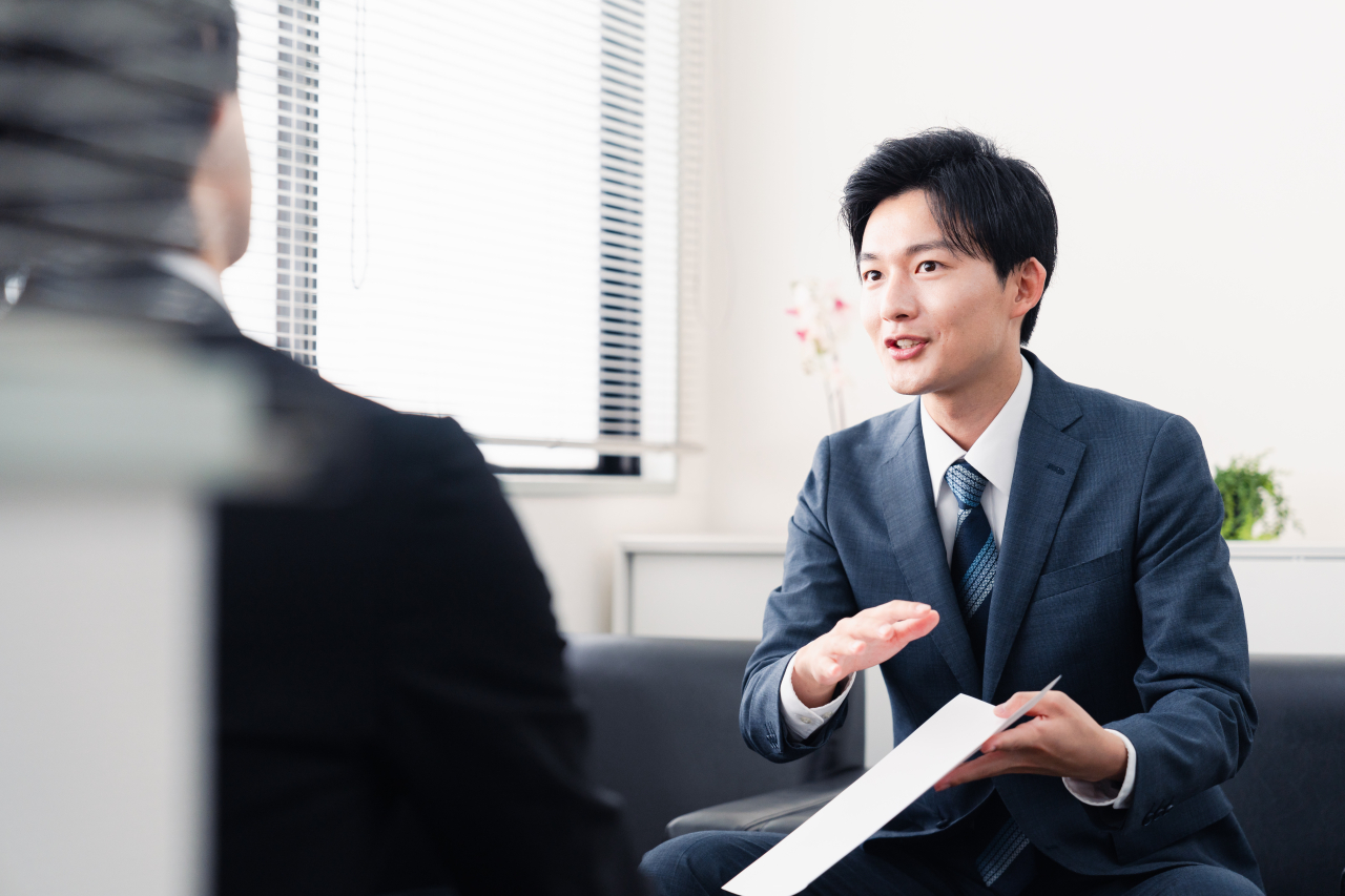 資料を見せながら説明をする男性
